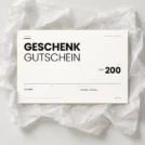 Inoiv Geschenkgutschein über CHF 200 auf weissem Seidenpapier